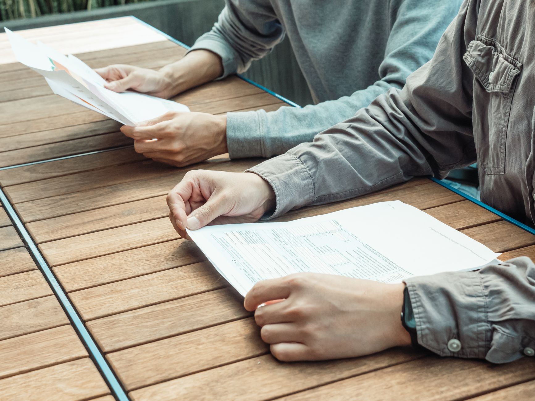 A student reviewing university application documents at a desk